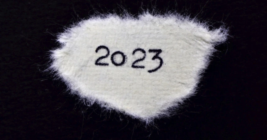 2023 typed on a piece of torn paper on a black background