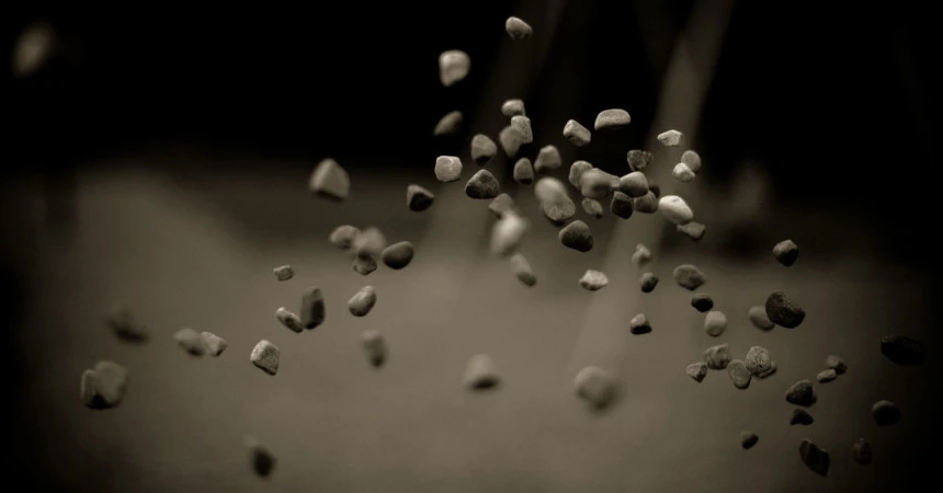 Throwing Stones - One of the official Ubuntu 9.10 wallpapers.
Showing a few stones in the air on a blurry background.